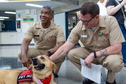 A therapy dog with its handlers in a clinical facility