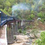 A train emerging in a mountain landscape