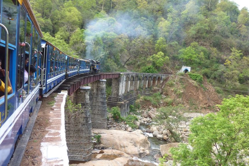 A train emerging in a mountain landscape