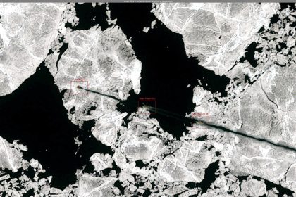 A cargo vessel navigating through icy Arctic waters