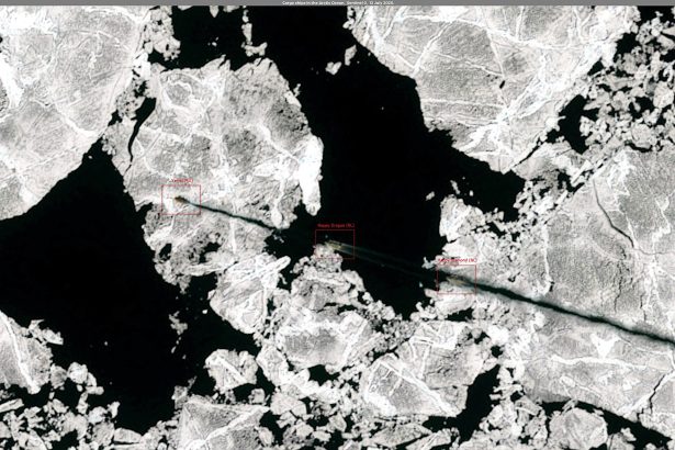 A cargo vessel navigating through icy Arctic waters